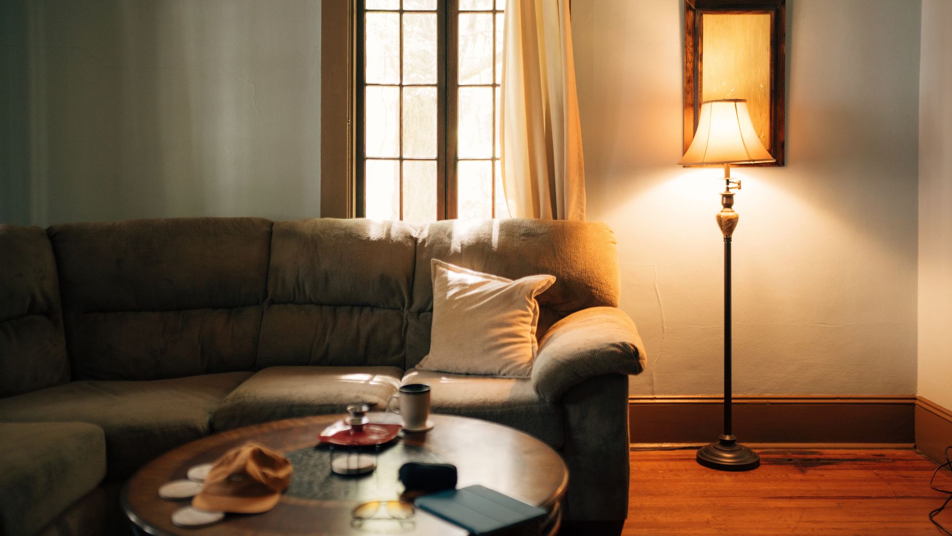 floor lamp glowing by a sofa